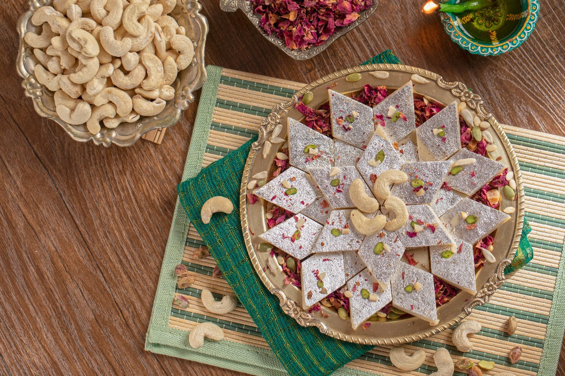 Kaju Katli Made By Lynk Foods Arranged In A Star Pattern On A Decorated Plate With Cashews And Rose Petals.